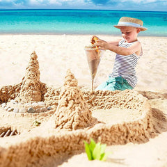 Beach toys overflowing sand from funnel